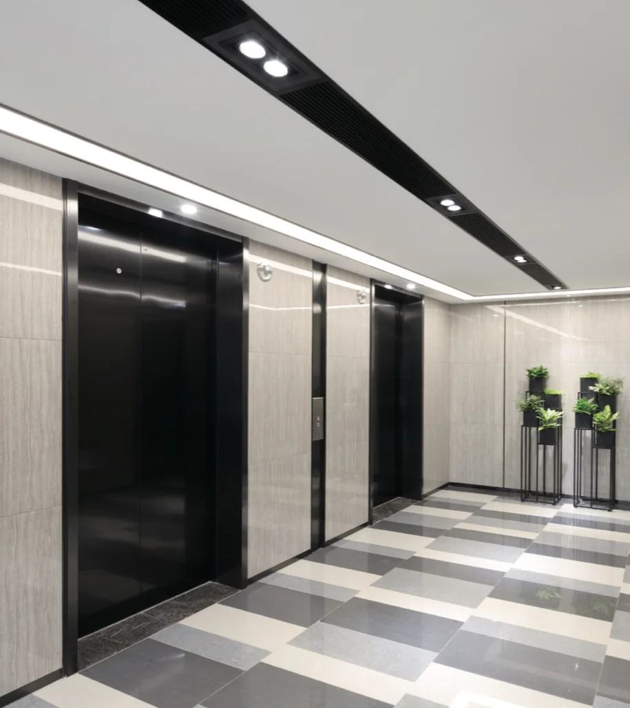 Passenger lift doors and controls in a commercial building lobby