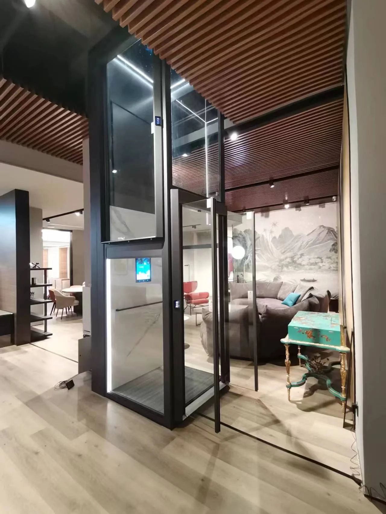 Glass home lift with a dark frame