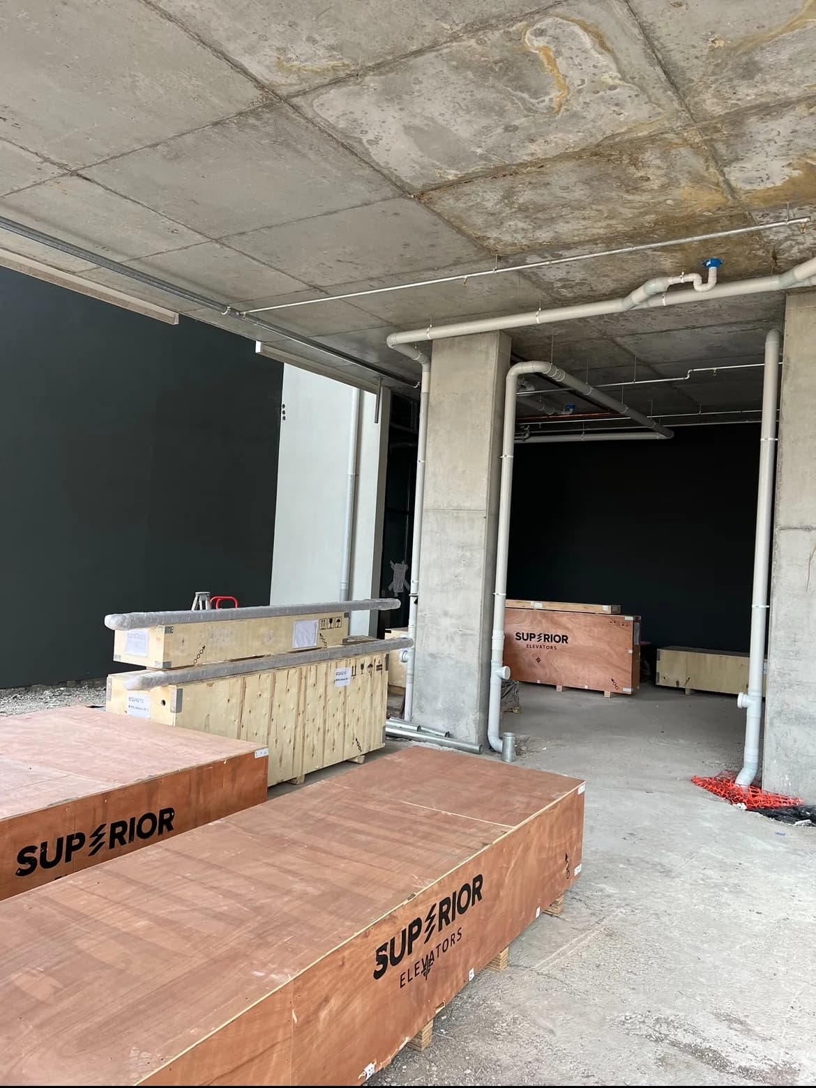 Superior Elevators installation materials and lift shaft at a building site